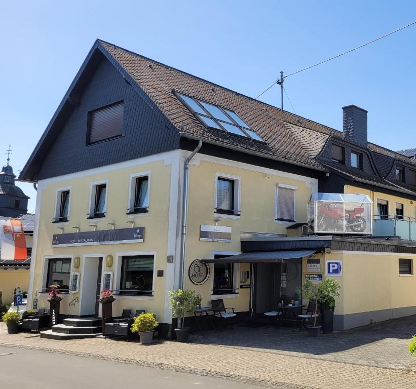 a large white building on the side of a street at Hotel & Restaurant Hüllen in Barweiler