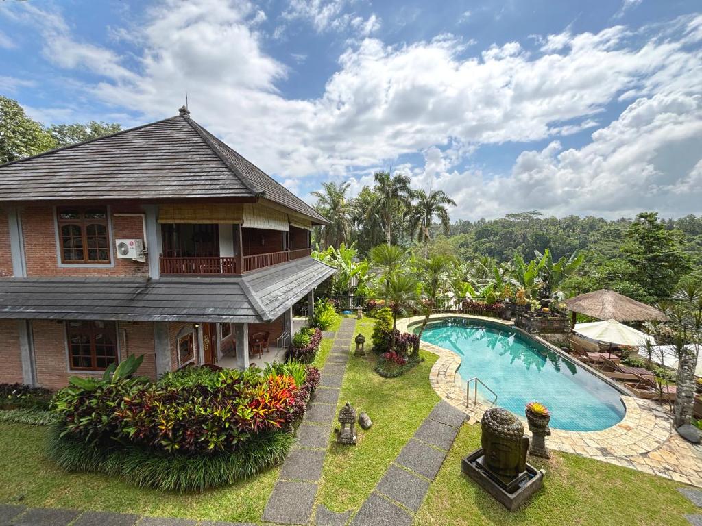 an aerial view of a house and a swimming pool at Hotel Bunga Permai in Ubud