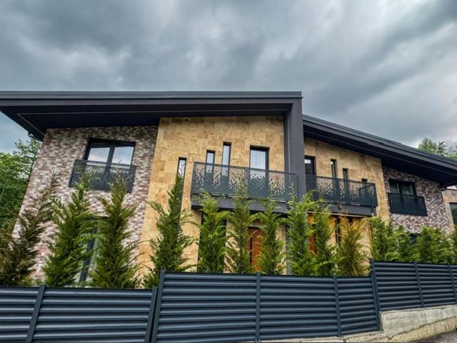 a building with a fence in front of it at Montéa Villa in Brezovica