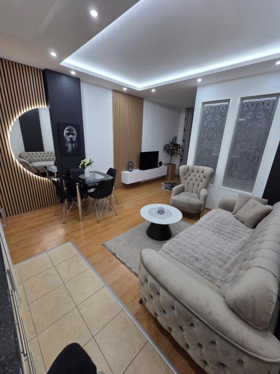 a living room with a couch and a table at Apartman Jezdić in Banja Koviljača