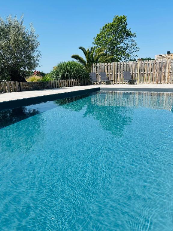 a large swimming pool with blue water at Le Clos de Kermadec in Kervignac