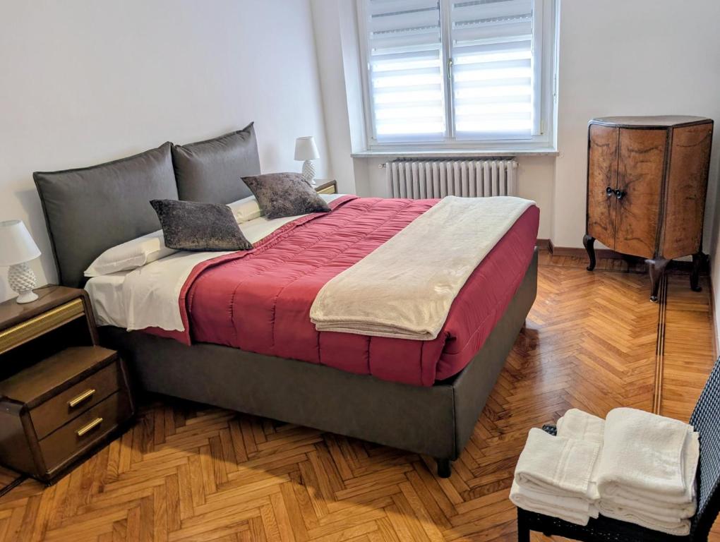 a bedroom with a large bed and a window at Monviso in Fossano