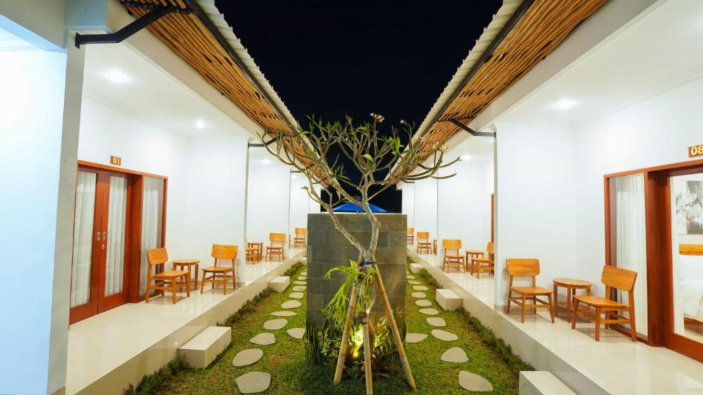 a room with a table and chairs and a plant at Royal Crown Villas in Ungasan