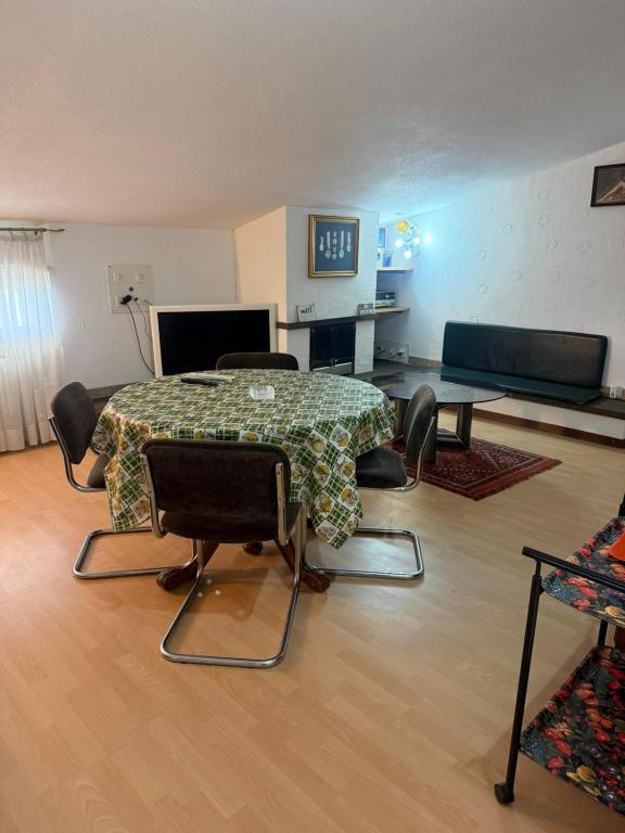 a living room with a table and a clock on the wall at La mansarda in Miranda