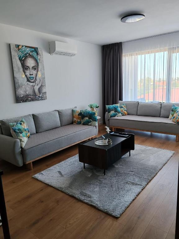 a living room with two couches and a coffee table at Sunny apartment208 in Dunajská Streda