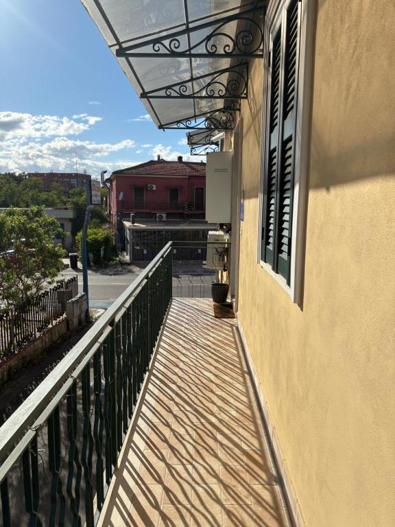 a balcony of a building with awning and a window at Guest House Marittima in Frosinone