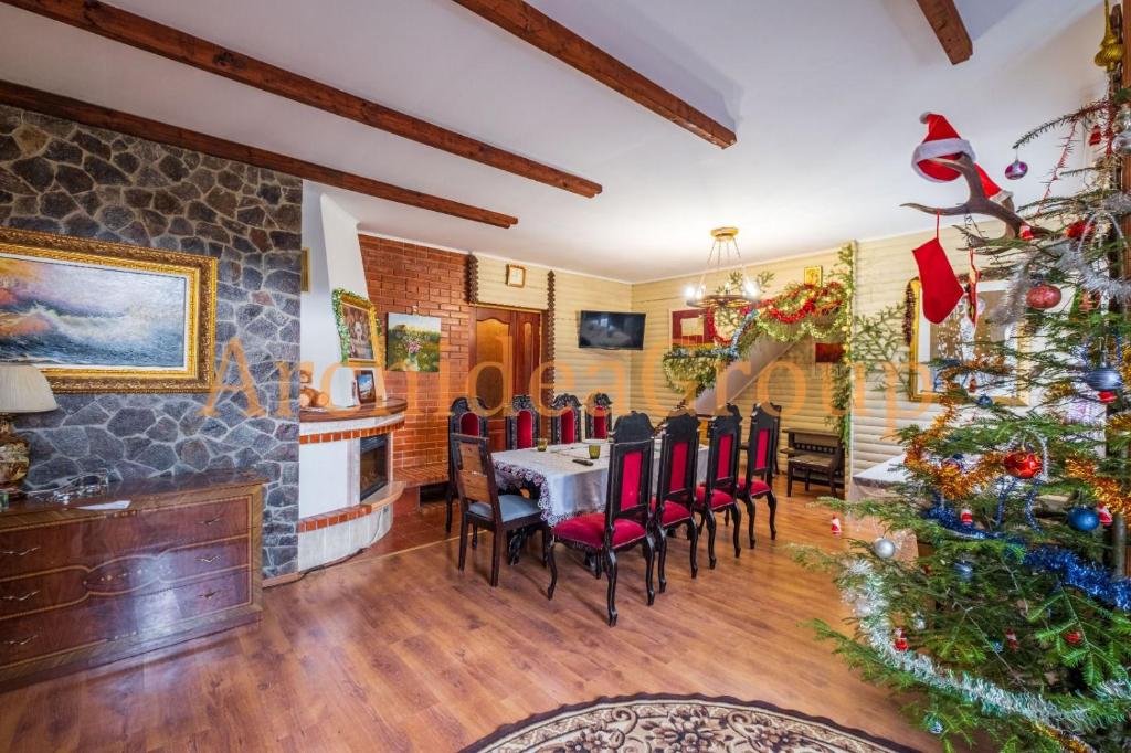 a dining room with a christmas tree and a table and chairs at Hotel palas tatarıv in Tatariv