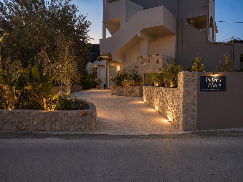 a building with a sign that reads plants have at Peter's Place Studios & Suites in Faliraki