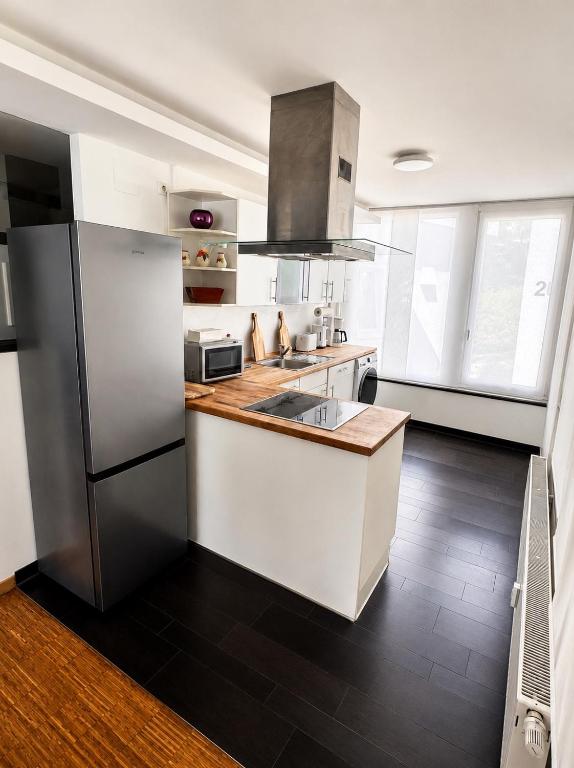 a kitchen with a refrigerator and a counter top at "Ferienhaus Wonderland in Coburg" - mit Terasse und Parking in Coburg