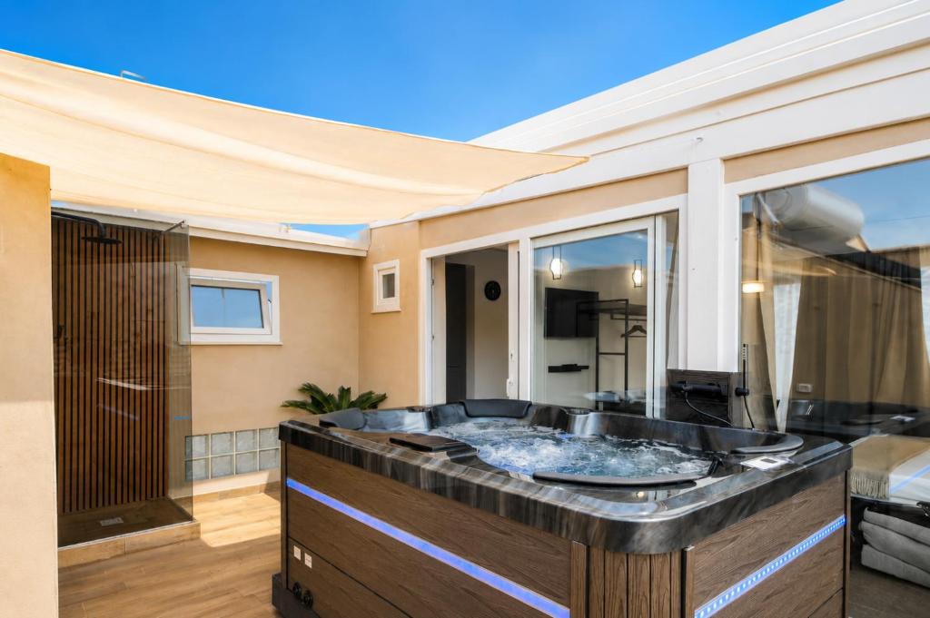 a jacuzzi tub in the middle of a patio at Saffi Suites in Noto