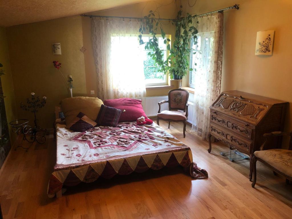 a bedroom with a bed and a dresser and a window at Sunny seaside place in Jūrmala