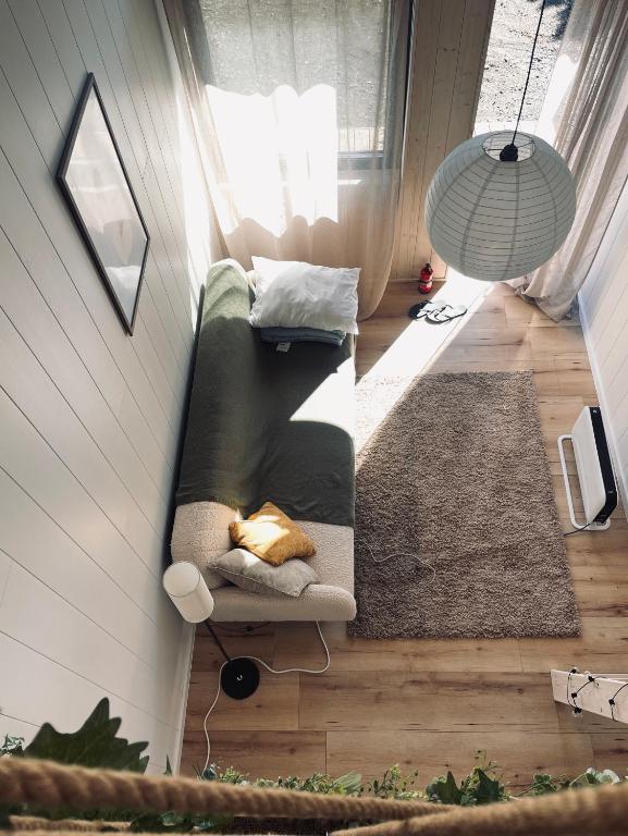 a small living room with a couch and a lamp at Airport Moonlight Tallinn in Tallinn