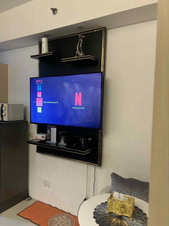 a flat screen tv hanging on a wall at JJ Staycation Tower 2 in Manila