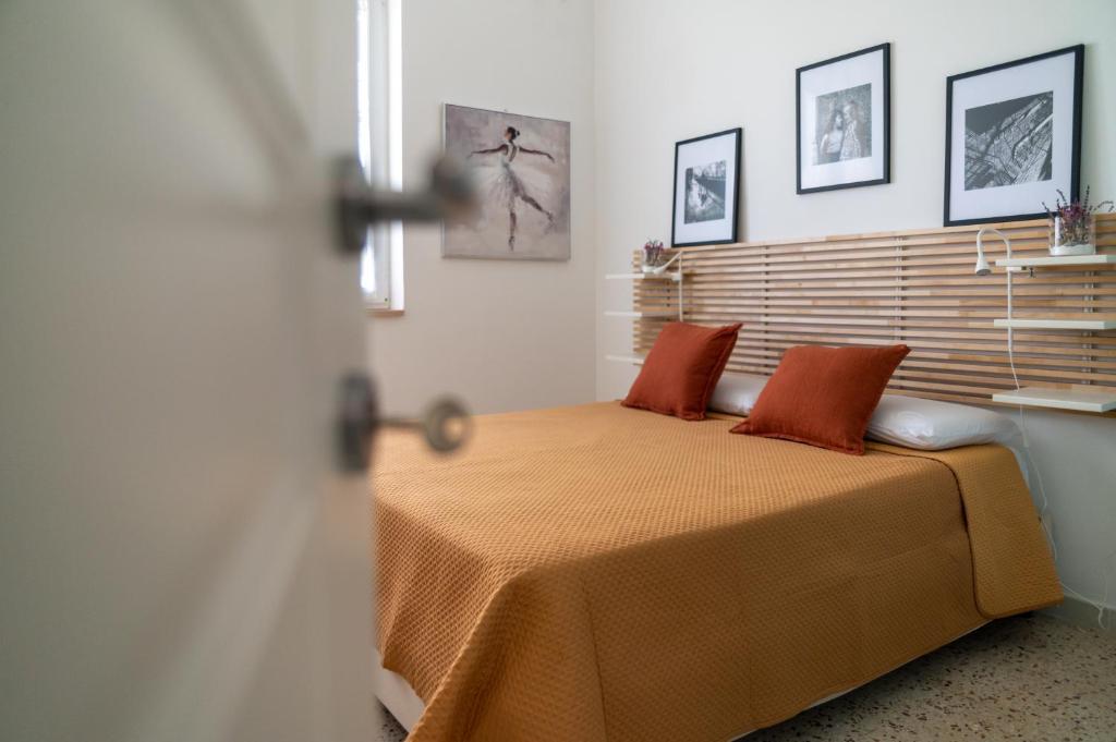 a bedroom with a bed with two red pillows at Cilento Reset in Sapri