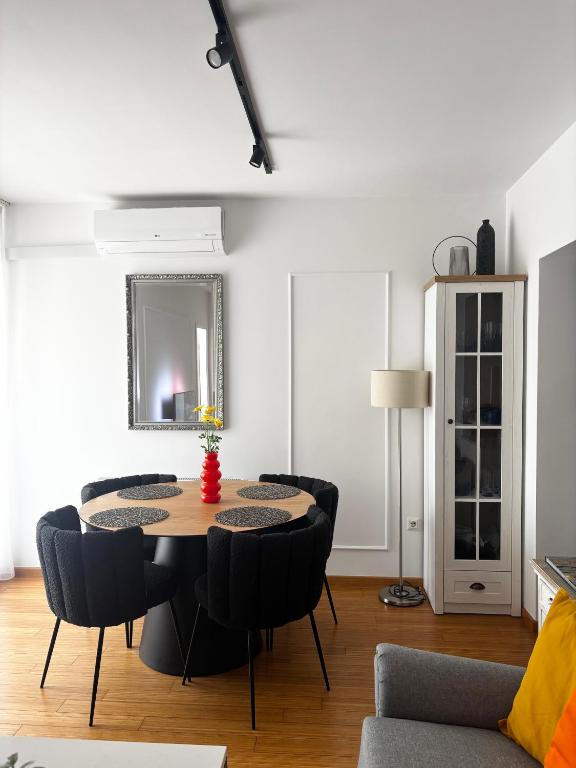 a dining room with a table and chairs at Apartment Rose in Sesvete