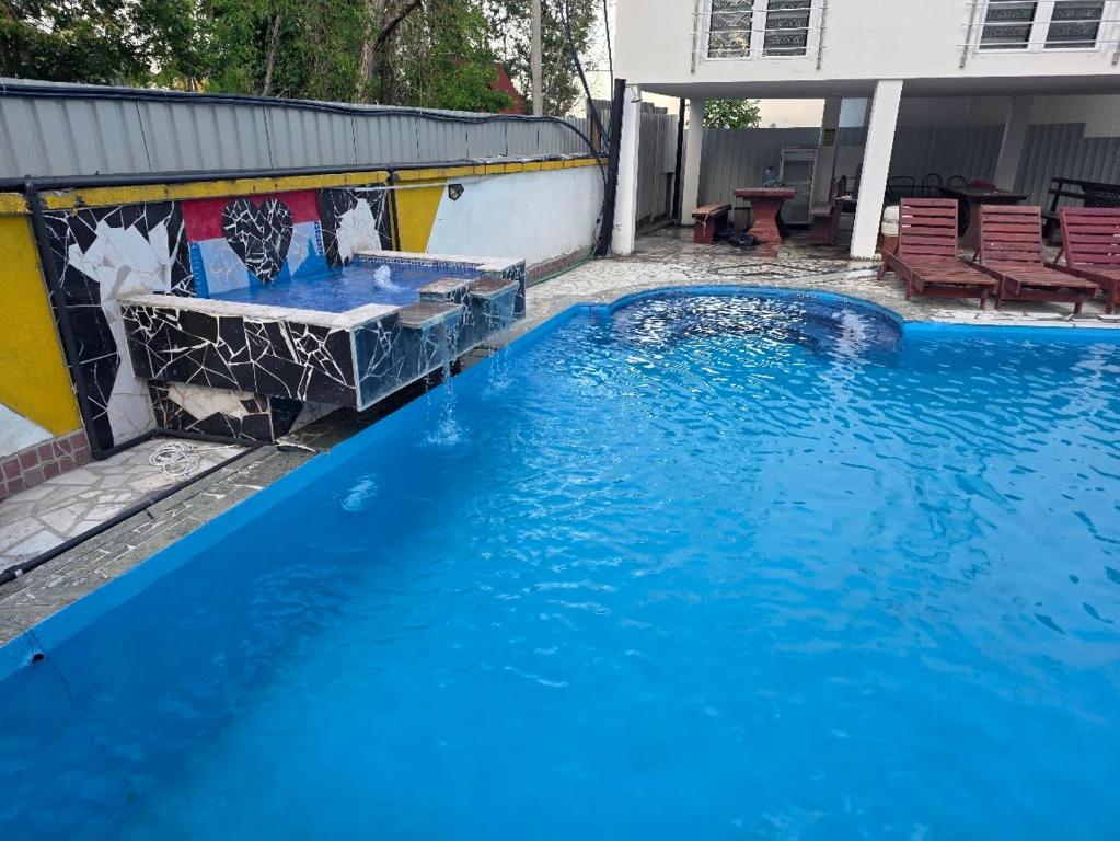 a large blue swimming pool in front of a house at Vila Darkoni2 in Bijeljina