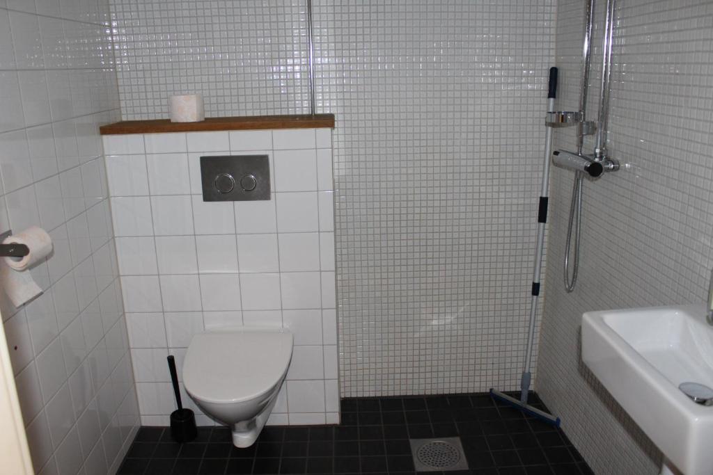 a bathroom with a toilet and a sink and a shower at Hostel Dalagatan in Stockholm