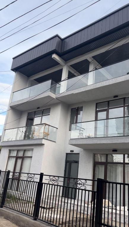 a building with a black fence in front of it at Hotel Tamarastan in Kobuleti
