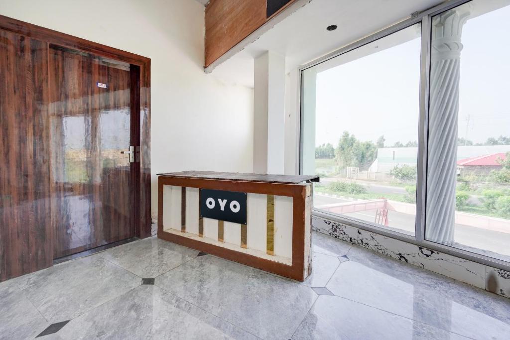 an open door with a no sign in a room with a window at Hotel O Highway Kitchen in Bara Khera
