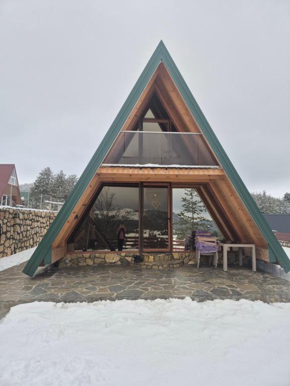 a frame house with a large window in the snow at Greenland in Žabljak