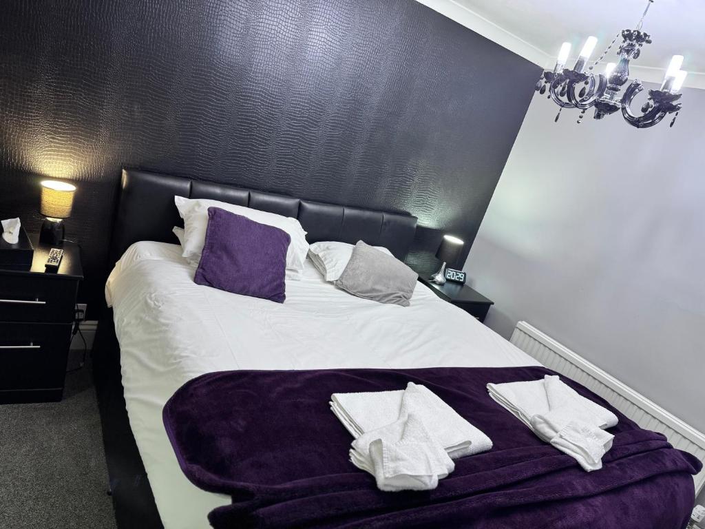 a bedroom with a bed with towels on it at Verve Hotel in Bedford