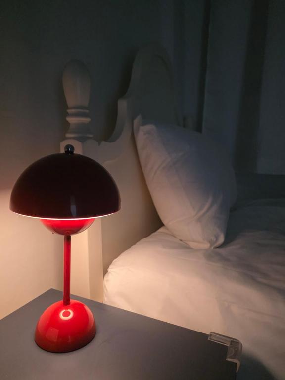 a red lamp sitting on a table next to a bed at Dear, U in Gyeongju