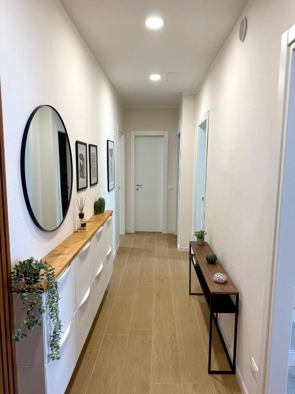 a hallway with a mirror and a table at Casa Tania in Massa
