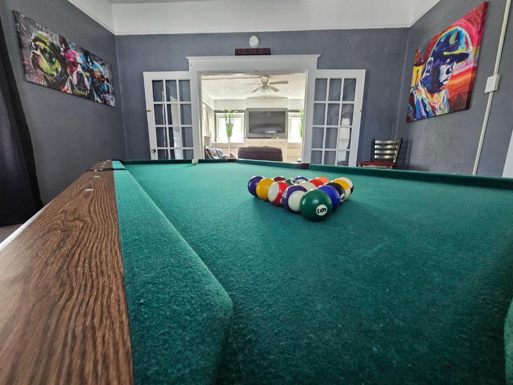 a pool table in a living room with a billiard at Huge 4-Bedroom Historic Home & Game Room in Goldsboro