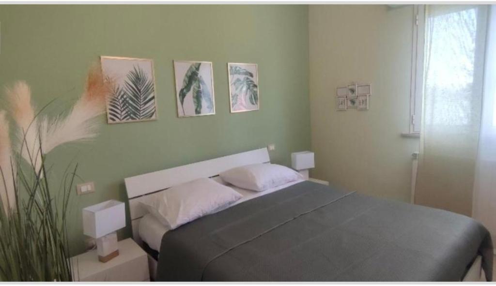 a bedroom with a bed and paintings on the wall at Camera matrimoniale - Villa Dalila in Silvi Paese