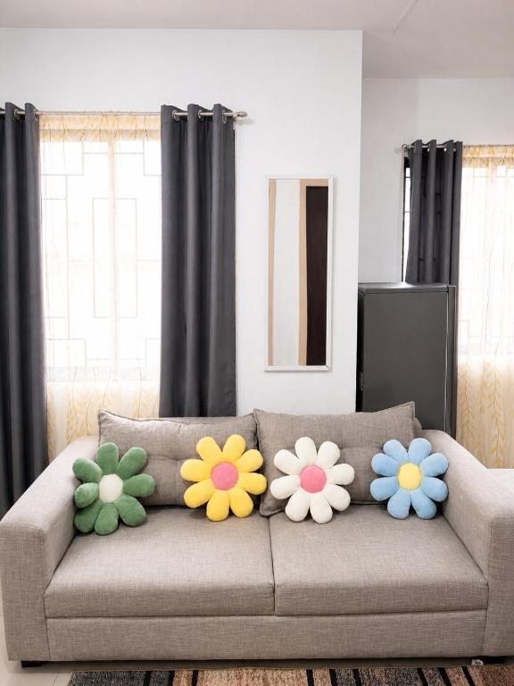 a couch with four colorful flowers on it at Balay in Butuan