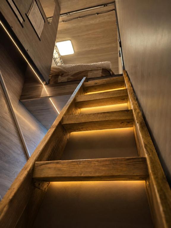 a staircase in a room with wooden walls and ceilings at Chip Central Host in Chişinău