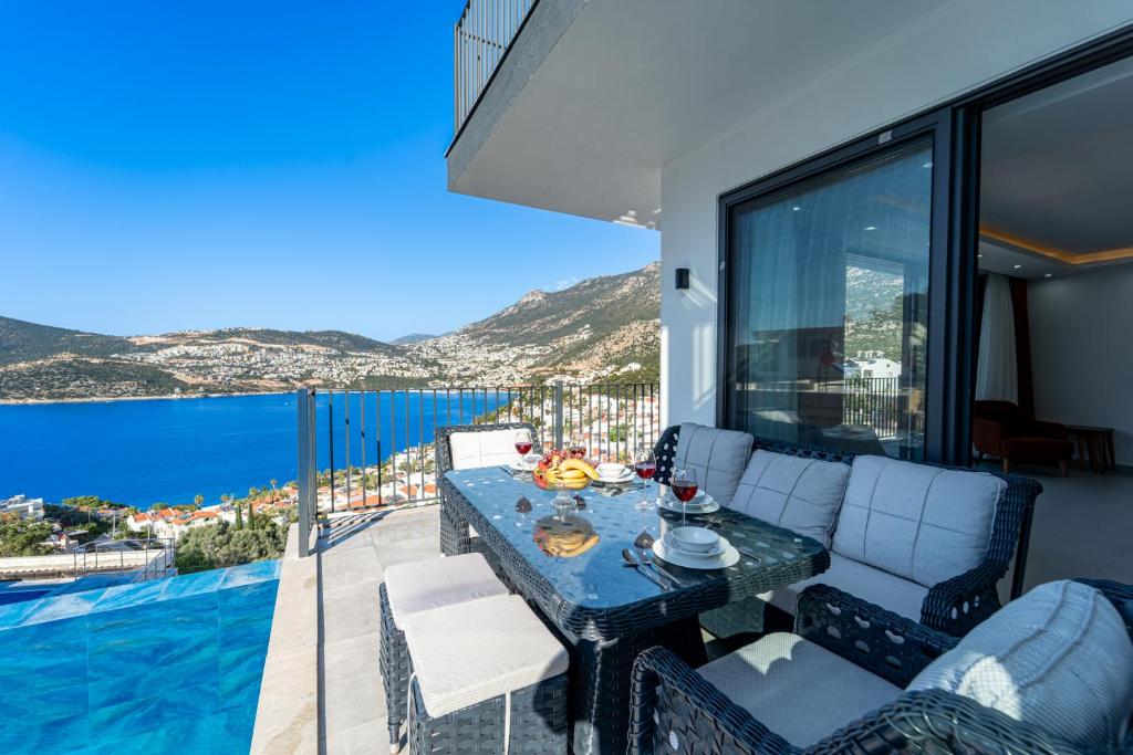 a balcony with a table and a view of the ocean at Villa Mavrem in Bezirgân