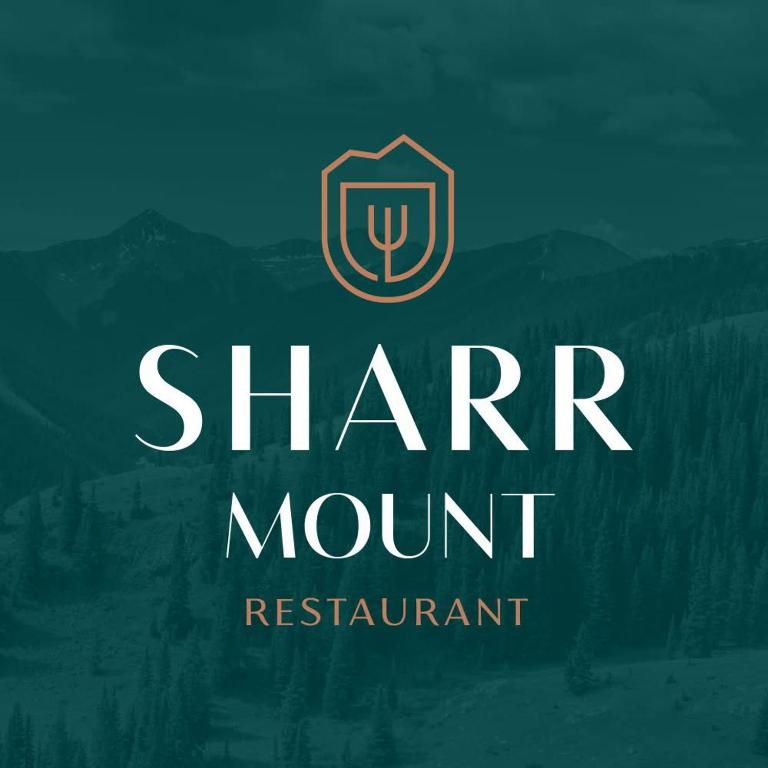 a logo for a sharm mountain restaurant with a shield at Sharr Mount in Prizren