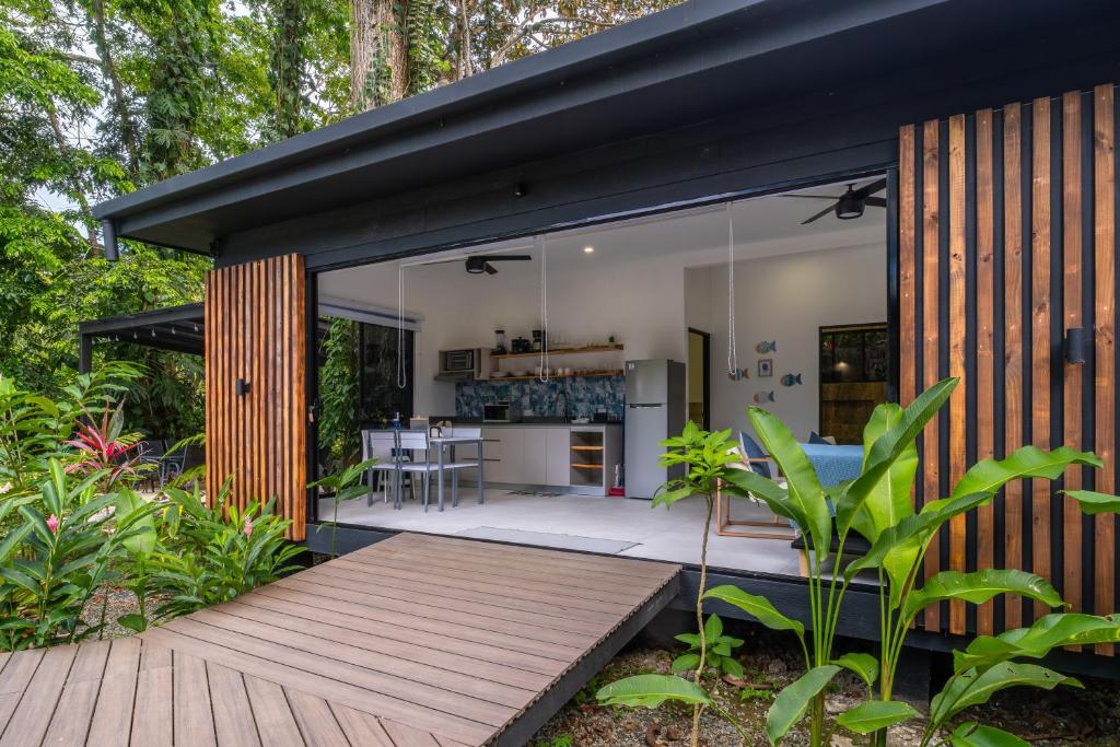 a house with glass walls and a wooden deck at Somnara Espuma de Mar Shared Pool in Punta Uva