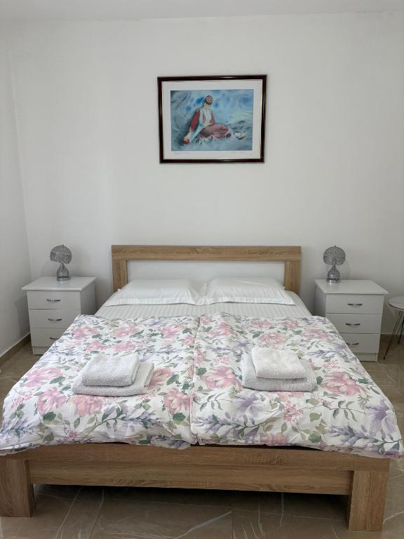 a bedroom with a bed with two towels on it at B&B Ana in Virpazar