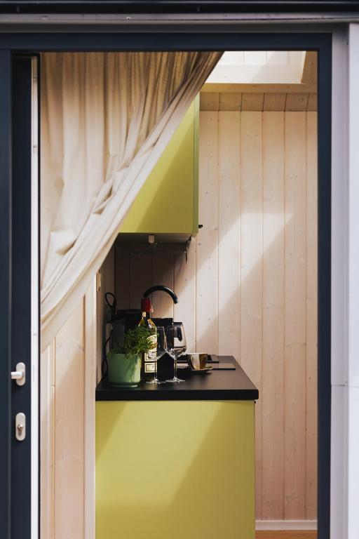 a kitchen with a counter and a sink in a room at Tiny House in Mechelinki