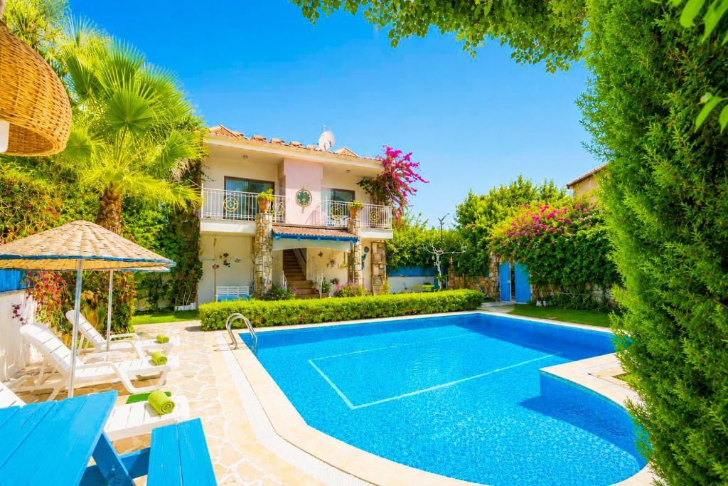 a villa with a swimming pool and a house at Villa Garden Island in Dalyan