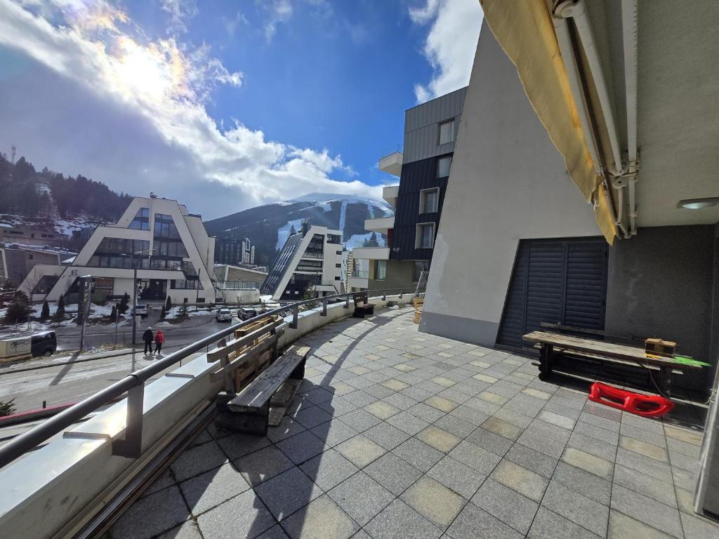 a balcony with benches and a view of a city at Ski & SunDeck in Bjelašnica