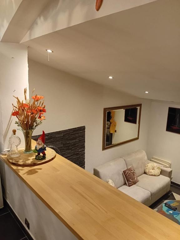 a living room with a counter and a couch at LE PANORAMIC- Sainte Agnès in Sainte-Agnès