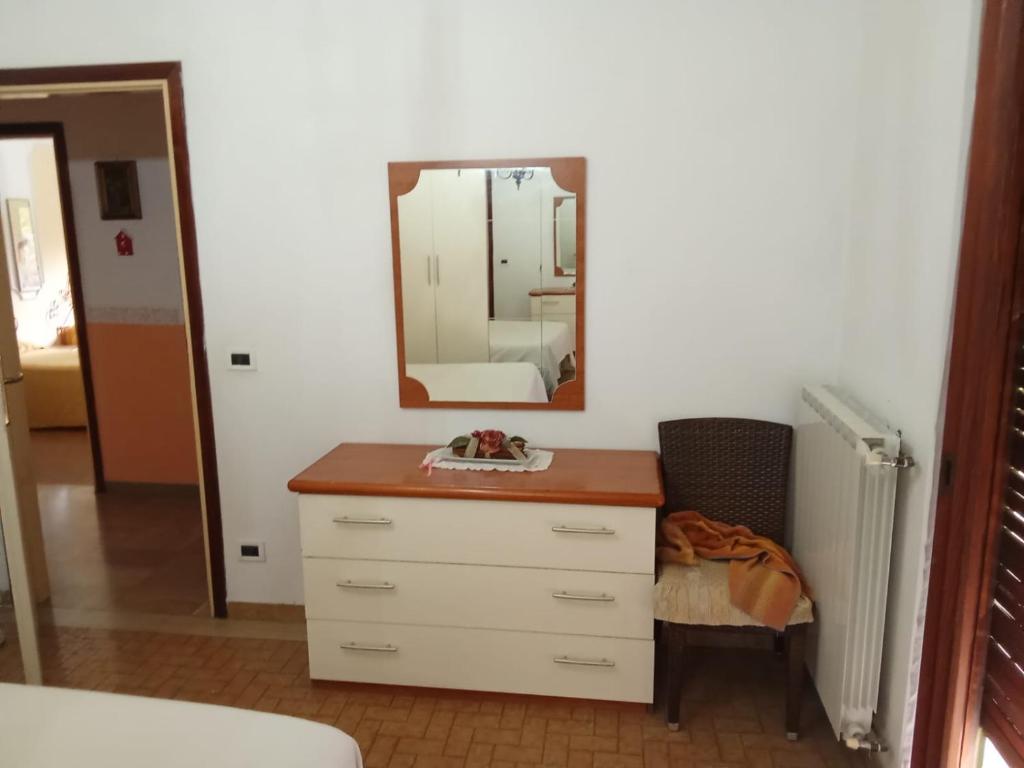 a bathroom with a dresser and a mirror at Caterina in Marina di Massa