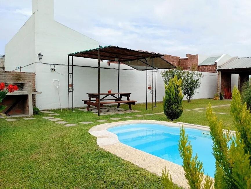 a patio with a picnic table and a picnic table and a picnic table at Los 3 Gurises in Gualeguay