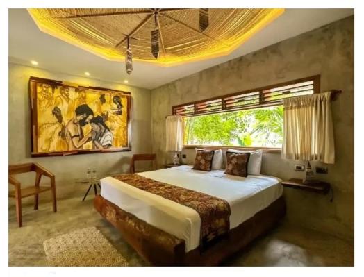 a bedroom with a large bed with a window at HOTEL ZAZIL KIN TULUM serenity & wellness in Tulum