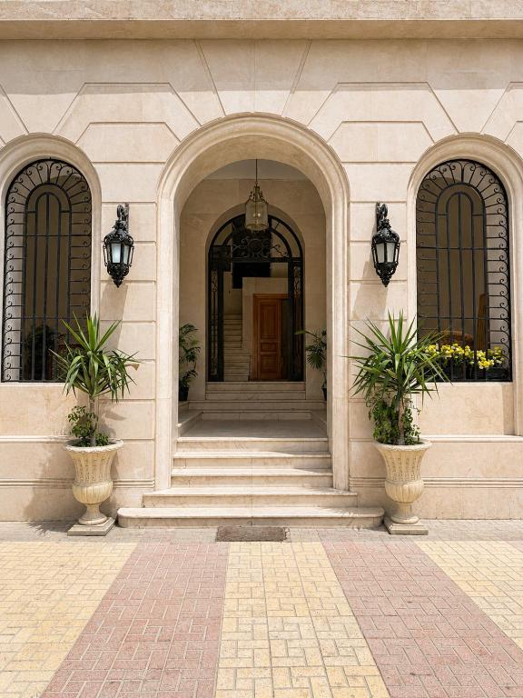 a building with two entry doors and two potted plants at 7 Heaven in Alexandria