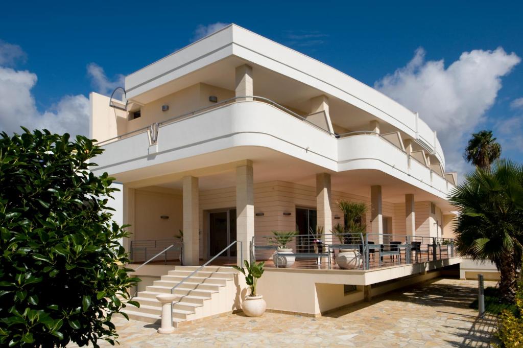 a large white house with a balcony at Residenza Del Mare in Sant'Isidoro