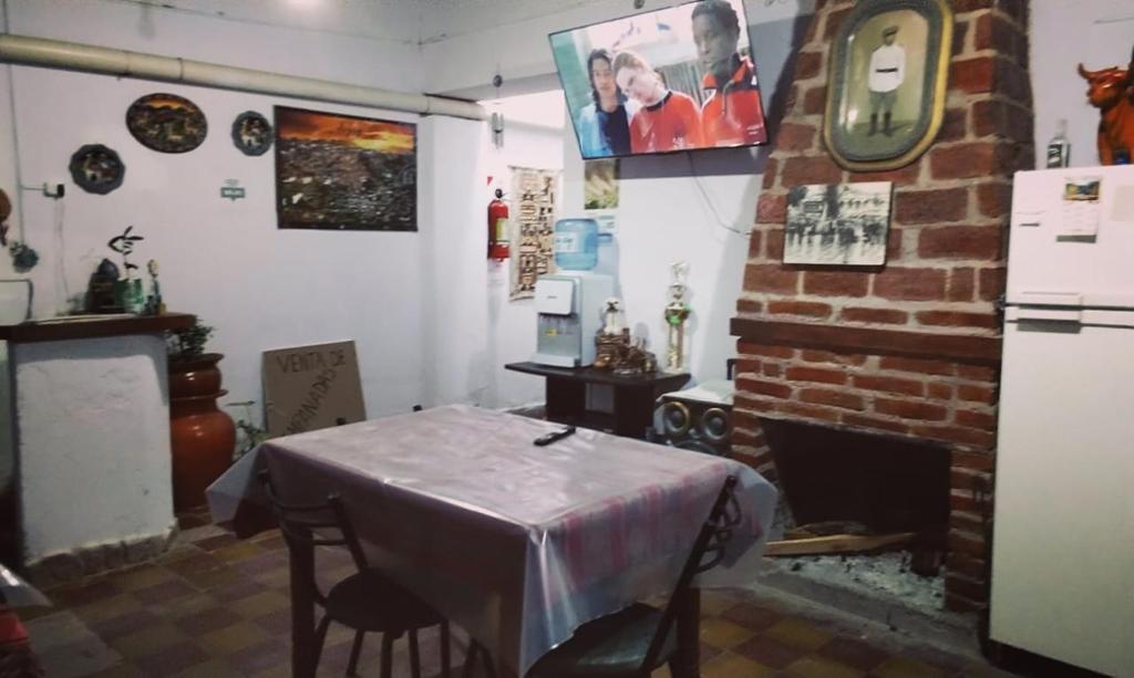 a dining room with a table and a fireplace at maimareña in Maimará