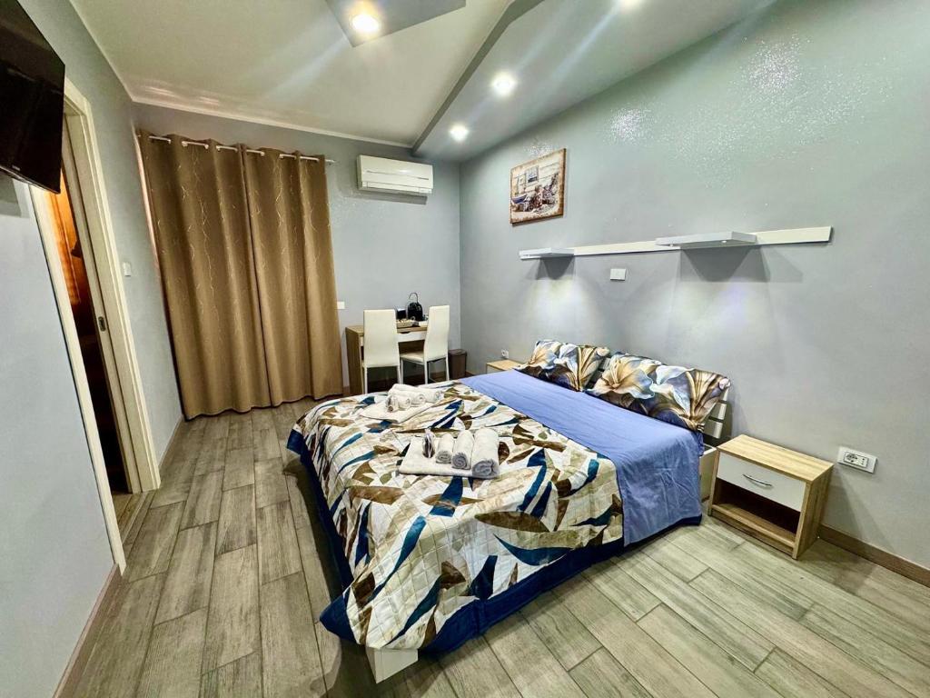 a bedroom with a bed and a table in it at The Queen Tropea in Tropea