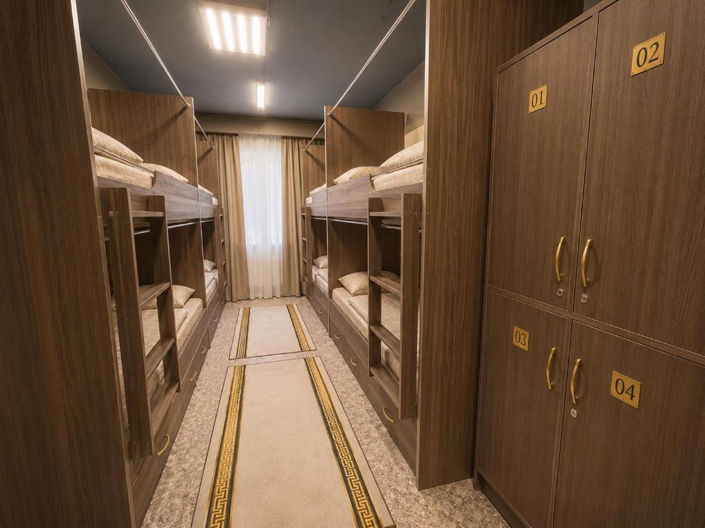 a corridor of a room with four bunk beds at Global Hostel in Almaty