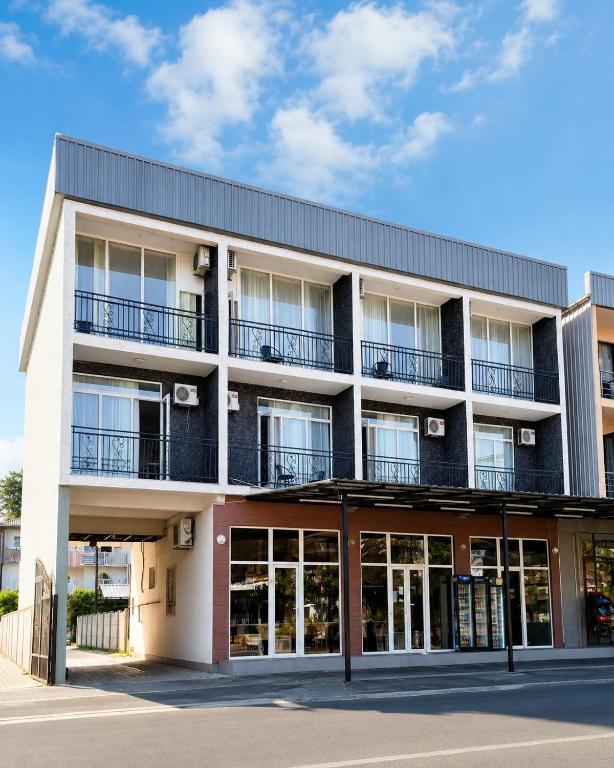 an apartment building with balconies and windows at Hotel Arev Kobuleti in Kobuleti