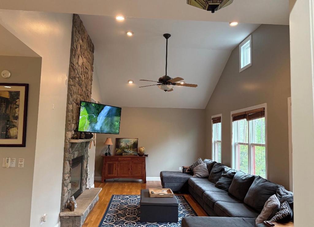 a living room with a couch and a fireplace at Lake Life Adventures 4 Bedroom Home in Lake Harmony
