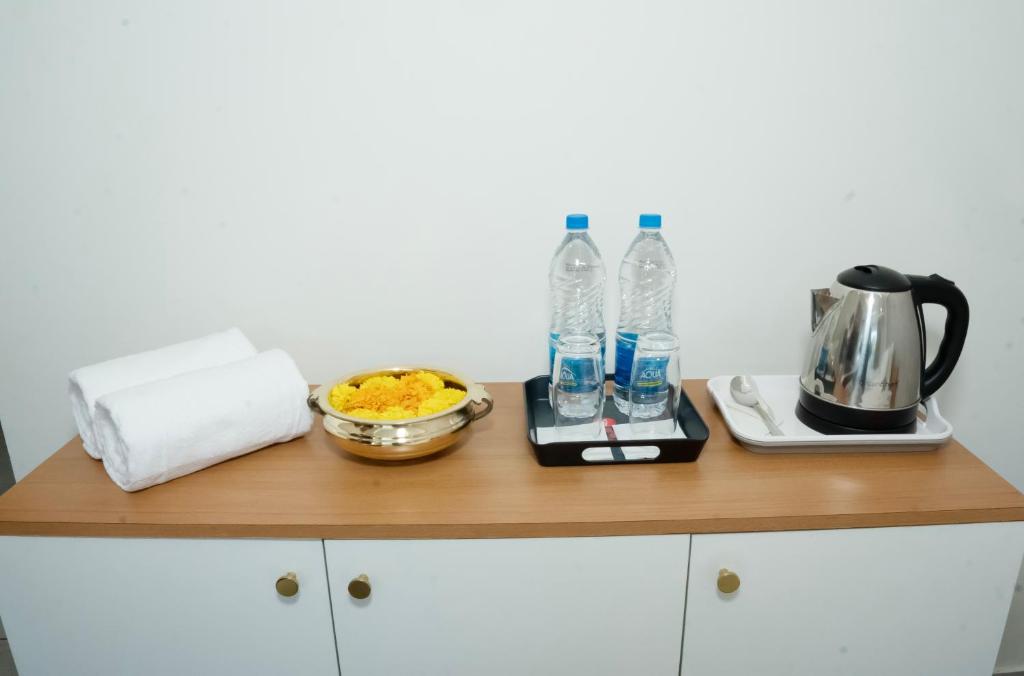 a counter with two bottles of water and a plate of food at UK Plaza in Edappāl